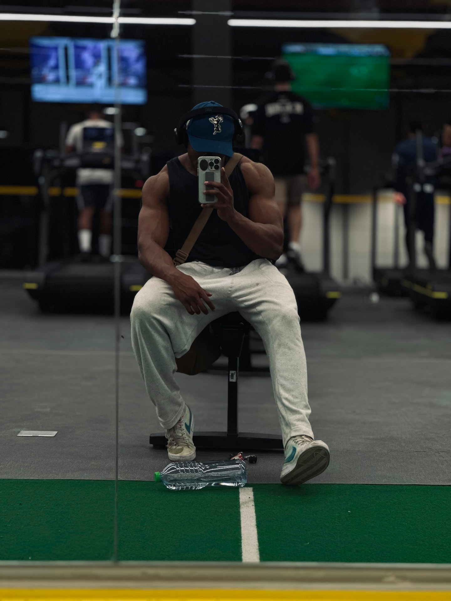Trainee resting on a bench in the gym